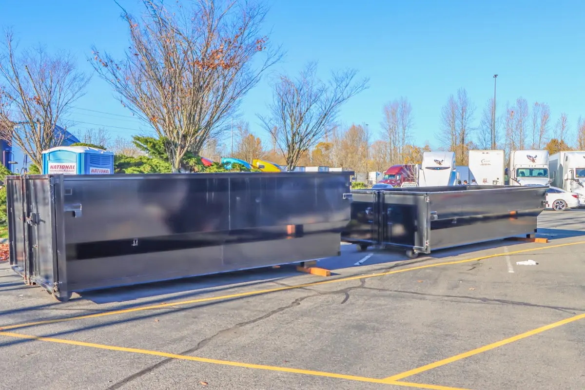 Professional dumpster rental service with roll-off container on residential driveway in Artesia